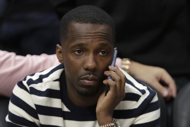 Sports agent Rich Paul, who represents several NBA players including LeBron James, talks on the phone after an NBA basketball game between the Miami Heat and the Charlotte Hornets, Wednesday, March 11, 2020, in Miami. The NBA has suspended its season