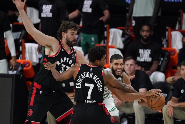 Boston Celtics' Jayson Tatum (0), right, drives around Toronto Raptors' Marc Gasol (33) and Kyle Lowry (7) during the first half of an NBA conference semifinal playoff basketball game Saturday, Sept. 5, 2020, in Lake Buena Vista, Fla. (AP Photo/Mark J. Terrill)
