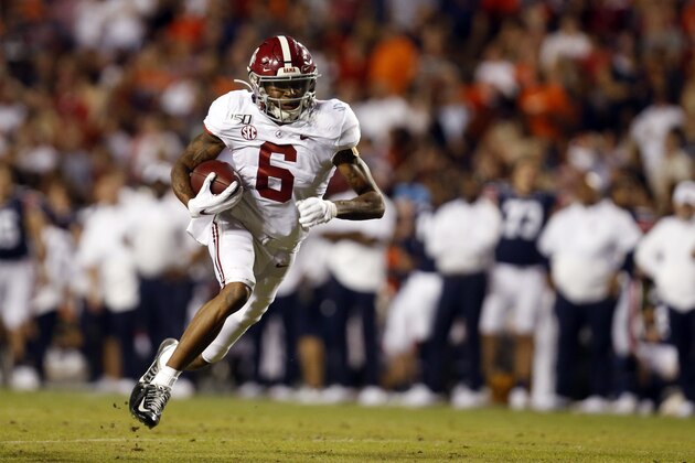 Alabama wide receiver DeVonta Smith (6) carries the ball after a reception against Auburn during the second half of an NCAA college football game Saturday, Nov. 30, 2019, in Auburn, Ala. (AP Photo/Butch Dill)