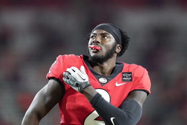 Georgia defensive back Richard LeCounte holds his shoulder during the first half of the team's NCAA college football game against Auburn, Saturday, Oct. 3, 2020, in Athens, Ga. (AP Photo/Brynn Anderson)