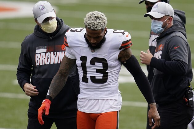 Cleveland Browns' Odell Beckham Jr. (13) is helped off the field during the first half of an NFL football game against the Cincinnati Bengals, Sunday, Oct. 25, 2020, in Cincinnati. (AP Photo/Michael Conroy)