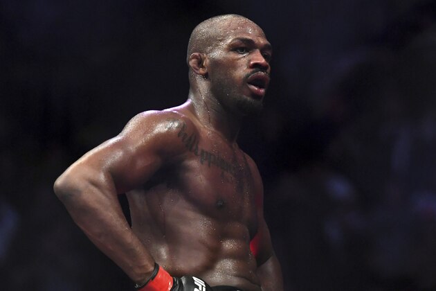 Jon Jones goes up on top of the octagon after defeating Alexander Gustafsson in the UFC men's light heavyweight mixed martial arts bout at UFC 232, Saturday, Dec. 29, 2018, in Inglewood, Calif. (AP Photo/Kyusung Gong)