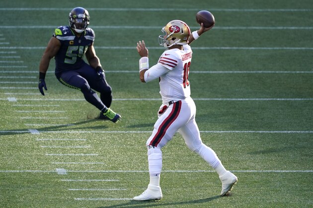 San Francisco 49ers quarterback Jimmy Garoppolo, right, passes as Seattle Seahawks middle linebacker Bobby Wagner (54) looks on at left, during the first half of an NFL football game, Sunday, Nov. 1, 2020, in Seattle. (AP Photo/Elaine Thompson)