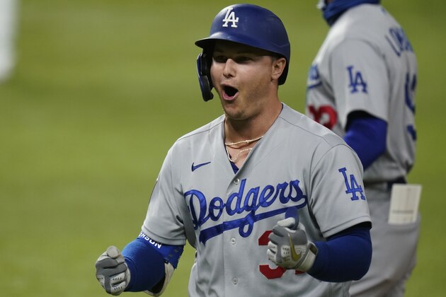 Los Angeles Dodgers' Joc Pederson celebrates his two RBI-single against the Tampa Bay Rays during the seventh inning in Game 4 of the baseball World Series Saturday, Oct. 24, 2020, in Arlington, Texas. (AP Photo/Eric Gay)