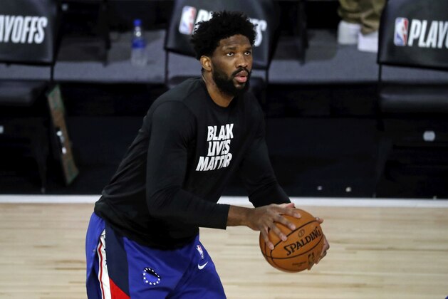 Philadelphia 76ers center Joel Embiid warms up prior to Game 3 of an NBA basketball first-round playoff series against the Boston Celtics, Friday, Aug. 21, 2020, in Lake Buena Vista, Fla. (Kim Klement/Pool Photo via AP)
