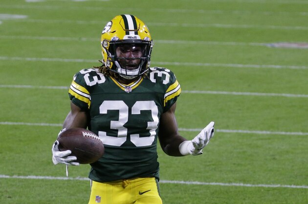 Green Bay Packers' Aaron Jones (33) reacts after a touchdown during the first half of an NFL football game against the Atlanta Falcons, Monday, Oct. 5, 2020, in Green Bay, Wis. (AP Photo/Tom Lynn)