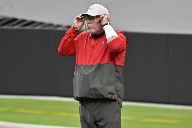 Tampa Bay Buccaneers head coach Bruce Arians adjusts a face shield before an NFL football game against the Las Vegas Raiders, Sunday, Oct. 25, 2020, in Las Vegas. (AP Photo/David Becker)