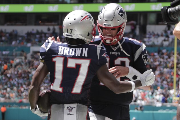 New England Patriots quarterback Tom Brady (12) wide receiver Antonio Brown (17) after Brown scored a touchdown, during the first half at an NFL football game against the Miami Dolphins, Sunday, Sept. 15, 2019, in Miami Gardens, Fla. (AP Photo/Lynne Sladky)