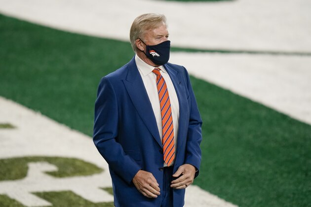 John Elway, president of football operations for the Denver Broncos, watches his team warm up before an NFL football game against the New York Jets Thursday, Oct. 1, 2020, in East Rutherford, N.J. (AP Photo/Seth Wenig)