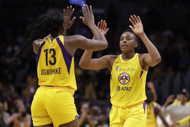 FILE - In this Friday, May 31, 2019, file photo, Los Angeles Sparks' Chiney Ogwumike (13) and her sister Nneka Ogwumike celebrate after a win over the Connecticut Sun in a WNBA basketball game in Los Angeles. Chiney Ogwumike doesn’t know what kind of reception she’ll get from the Connecticut Sun fans when her new team, the Los Angeles Sparks, visit on Thursday.  She’ll understand if the fans boo her after she asked for a trade to Los Angeles in the offseason. Meanwhile, she’s having a great time in Los Angeles with her new team and her sister Nneka. AP Photo/Marcio Jose Sanchez, File)