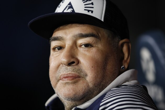 FILE - In this March 7, 2020 file photo, Diego Maradona, coach of Gimnasia y Esgrima, sits on the bench prior to Argentina's soccer league match against Boca Juniors at La Bombonera stadium in Buenos Aires, Argentina. Maradona turns 60 on Friday, Oct. 30, 2020. (AP Photo/Natacha Pisarenko, File)