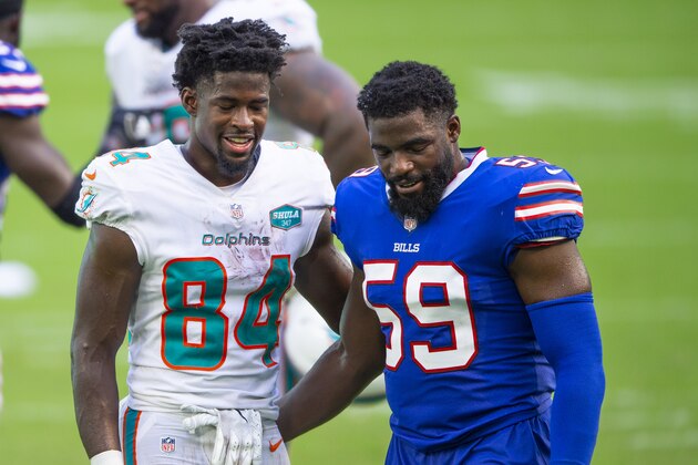 Miami Dolphins wide receiver Isaiah Ford (84) and Buffalo Bills linebacker Andre Smith (59) smile and talk on the field after an NFL football game, Sunday, Sept. 20, 2020, in Miami Gardens, Fla. (AP Photo/Doug Murray)