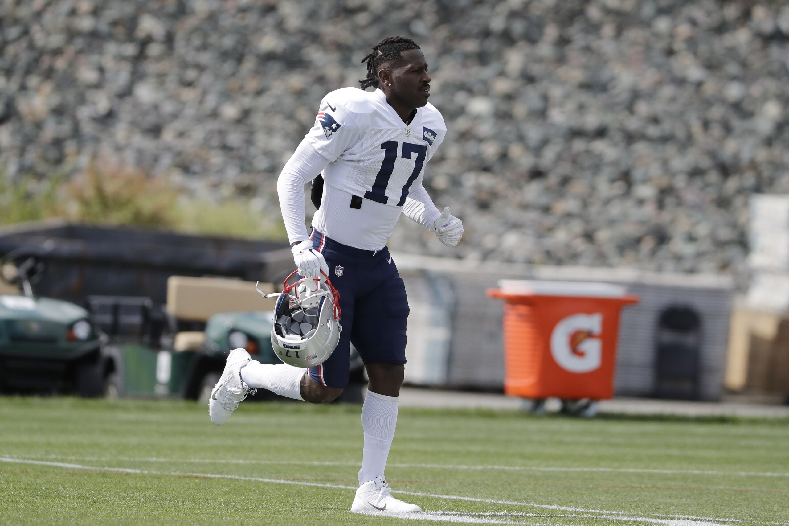 New England Patriots wide receiver Antonio Brown carries his helmet during an NFL football practice, Wednesday, Sept. 18, 2019, in Foxborough, Mass. (AP Photo/Steven Senne)