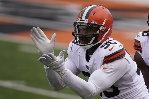 Cleveland Browns' Myles Garrett (95) reacts after a sack during the first half of an NFL football game against the Cincinnati Bengals, Sunday, Oct. 25, 2020, in Cincinnati. (AP Photo/Michael Conroy)