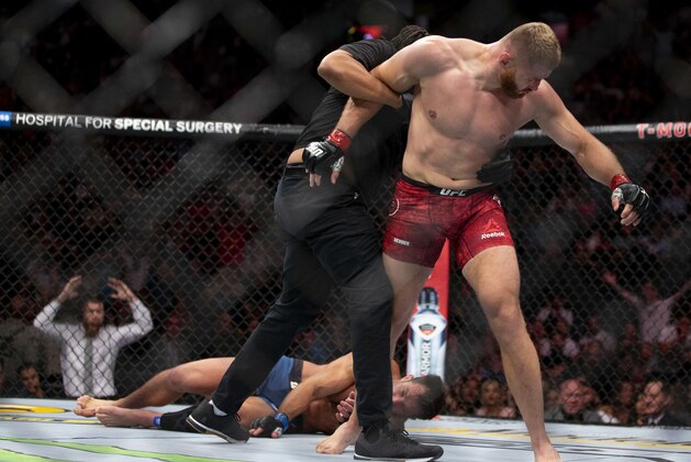 Jan Blachowicz, right, reacts after knocking out Luke Rockhold during the second round of their light heavyweight mixed martial arts bout at UFC 239, Saturday, July 6, 2019, in Las Vegas. (AP Photo/Eric Jamison)