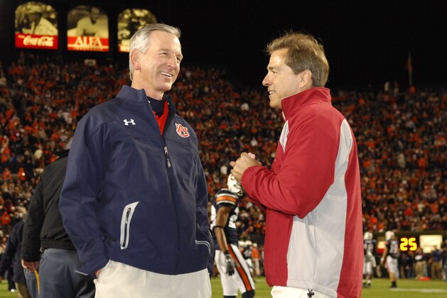 Auburn coach Tommy Tuberville, left, and Alabama coach Nick Saban, right, talk before the start of the Iron Bowl football game, Saturday Nov. 24, 2007, in Auburn, Ala. (AP Photo/Todd Van Emst)
