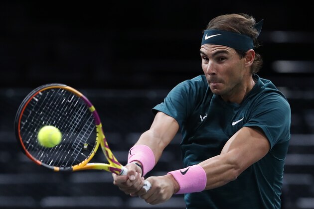 Spain's Rafael Nadal returns to compatriot Feliciano Lopez during the second round of the Paris Masters tennis tournament at the Bercy Arena in Paris, Wednesday, Nov. 4, 2020. (AP Photo/Thibault Camus)