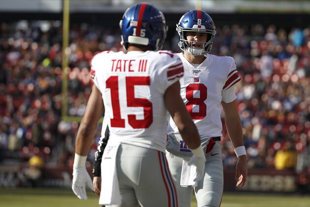 New York Giants quarterback Daniel Jones (8) talks with wide receiver Golden Tate (15) during the first half of an NFL football game against the Washington Redskins, Sunday, Dec. 22, 2019, in Landover, Md. (AP Photo/Alex Brandon)