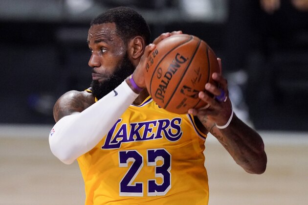 Los Angeles Lakers forward LeBron James grabs a rebound during the second half in Game 4 of basketball's NBA Finals against the Miami Heat Tuesday, Oct. 6, 2020, in Lake Buena Vista, Fla. (AP Photo/Mark J. Terrill)