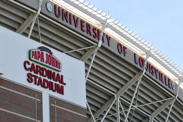 The Papa John's Pizza logo hangs on one of the many signs on the outside of the University of Louisville's Cardinal Stadium, Tuesday, July 17, 2018, in Louisville, Ky. (AP Photo/Timothy D. Easley)