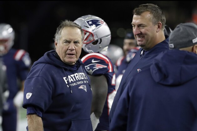 New England Patriots head coach Bill Belichick, left, speaks with defensive line coach Bret Bielema on the sideline in the second half of an NFL football game against the New York Giants, Thursday, Oct. 10, 2019, in Foxborough, Mass. (AP Photo/Elise Amendola)