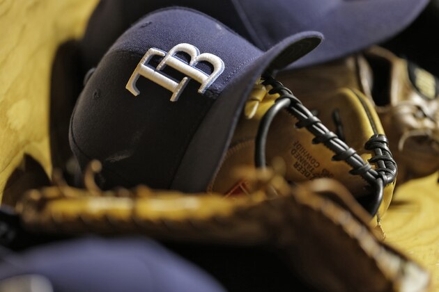 Tampa Bay Rays hats and gloves on the bench during the seventh inning of an interleague baseball game against the Atlanta Braves Wednesday, Aug. 12, 2015, in St. Petersburg, Fla. (AP Photo/Chris O'Meara)