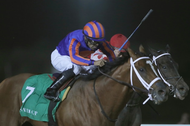 Jockey Luis Saez rides his horse, Maximum Security as he reaches the finish line of the $20 million, the Saudi Cup, at King Abdul Aziz race track in Riyadh, Saudi Arabia, Saturday, Feb. 29, 2020. The race is considered the world's richest horse race which attracted some of the world's best male and female jockeys. (AP Photo/Amr Nabil)
