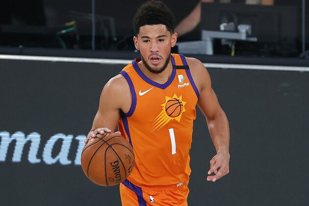 Phoenix Suns' Devin Booker dribbles the ball down court against the Indiana Pacers during the first half of an NBA basketball game Thursday, Aug. 6, 2020, in Lake Buena Vista, Fla. (Kevin C. Cox/Pool Photo via AP)