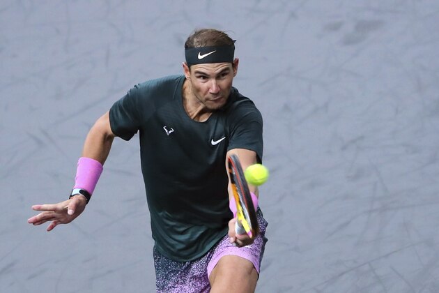 Spain's Rafael Nadal returns to compatriot Pablo Carreno Busta during their quarter-final game of the Paris Masters tennis tournament at the Bercy Arena in Paris, Friday, Nov. 6, 2020. (AP Photo/Thibault Camus)