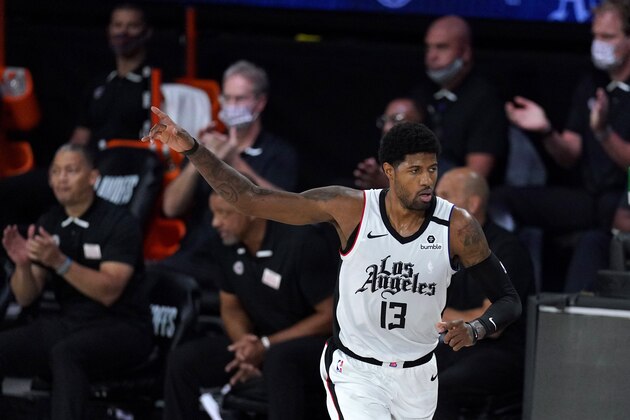 Los Angeles Clippers' Paul George reacts after making a three-pointer during the first half of an NBA conference semifinal playoff basketball game against the Denver Nuggets, Friday, Sept. 11, 2020, in Lake Buena Vista, Fla. (AP Photo/Mark J. Terrill)