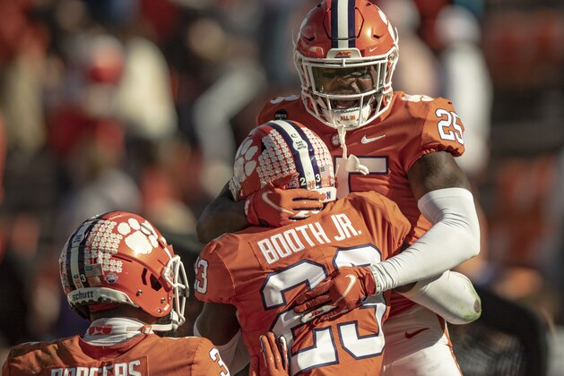 Clemson safety Jalyn Phillips (25) celebrates a defensive stop with cornerback Andrew Booth Jr. (23) during the second half of an NCAA college football game  Saturday, Oct. 31, 2020, in Clemson, S.C. (Josh Morgan/Pool Photo via AP)