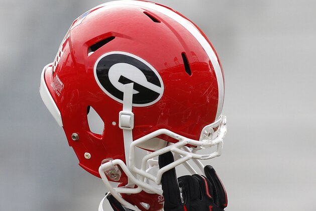 Georgia helmet in the air before a game against Georgia Tech of an NCAA college football game Saturday, Nov. 28, 2015, in Atlanta. (AP Photo/Brett Davis)
