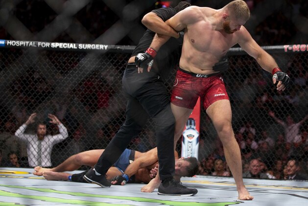 Jan Blachowicz, right, reacts after knocking out Luke Rockhold during the second round of their light heavyweight mixed martial arts bout at UFC 239, Saturday, July 6, 2019, in Las Vegas. (AP Photo/Eric Jamison)