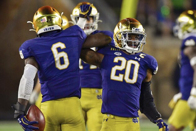 Notre Dame linebacker Jeremiah Owusu-Koramoah (6) and safety Shaun Crawford (20) celebrate after a third-quarter stop against the Clemson in an NCAA college football game Saturday, Nov. 7, 2020, in South Bend, Ind. (Matt Cashore/Pool Photo via AP)