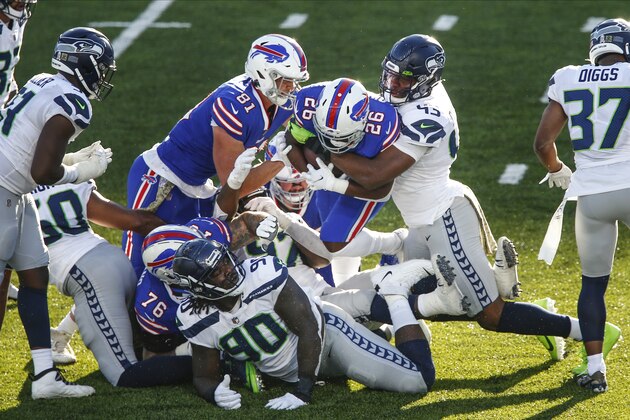 Seattle Seahawks Carlos Dunlap (43) tackles Seattle Seahawks' Shaquill Griffin (26) during the second half of an NFL football game Sunday, Nov. 8, 2020, in Orchard Park, N.Y. (AP Photo/John Munson)