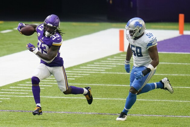 Minnesota Vikings running back Dalvin Cook (33) runs from Detroit Lions linebacker Reggie Ragland, right, during the second half of an NFL football game, Sunday, Nov. 8, 2020, in Minneapolis. (AP Photo/Jim Mone)