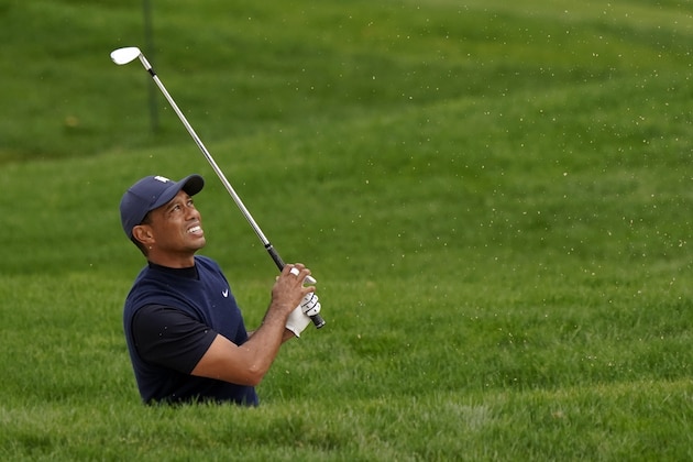 Tiger Woods watches his shot from the bunker off the 10th fairway during the third round of the Zozo Championship golf tournament Saturday, Oct. 24, 2020, in Thousand Oaks, Calif. (AP Photo/Marcio Jose Sanchez)