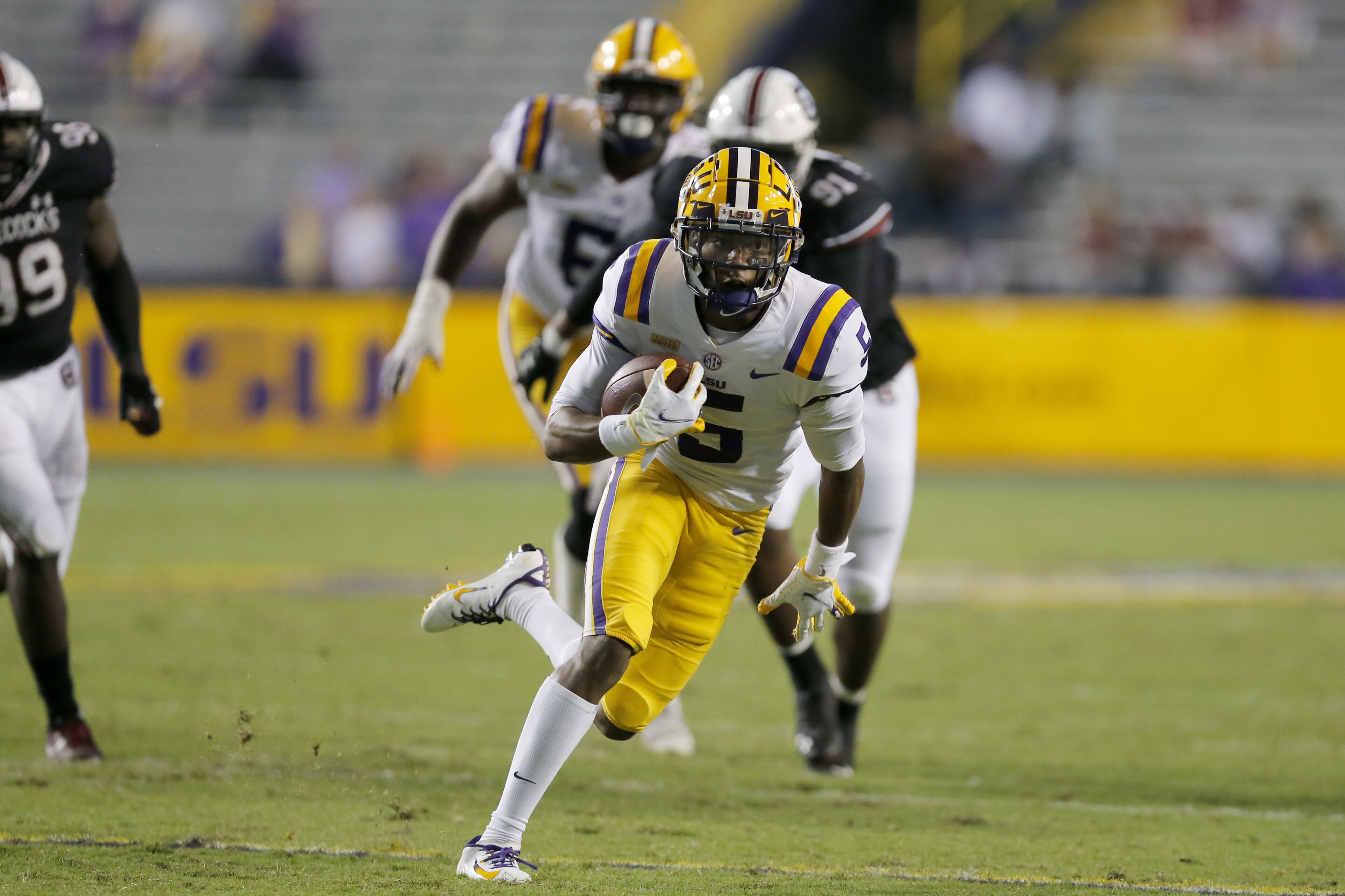 LSU wide receiver Koy Moore (5) runs the ball against South Carolina during second half of an NCAA college football game in Baton Rouge, La. Saturday, Oct. 24, 2020. (AP Photo/Brett Duke) LSU wide receiver Koy Moore (5) runs the ball against South Carolina during second half of an NCAA college football game in Baton Rouge, La. Saturday, Oct. 24, 2020. (AP Photo/Brett Duke)