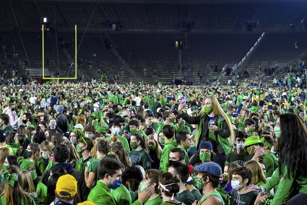 Fans storm the field after Notre Dame defeated the Clemson 47-40 in two overtimes in an NCAA college football game Saturday, Nov. 7, 2020, in South Bend, Ind. (Matt Cashore/Pool Photo via AP)