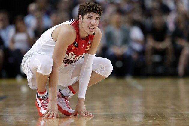 FILE-  In this Nov. 17, 2019, file photo, LaMelo Ball of the Illawarra Hawks squats during their game against the Sydney Kings in the Australian Basketball League in Sydney. The point guard from California who bypassed college and played overseas is expected to be one of the top picks when the twice-delayed NBA draft is held in November.  (AP Photo/Rick Rycroft, File)