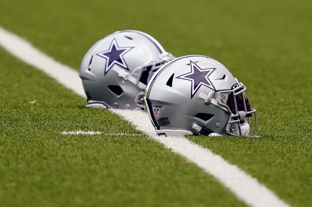 Dallas Cowboys helmets sit on the field during an NFL training camp football practice in Frisco, Texas, Thursday, Sept. 3, 2020. (AP Photo/LM Otero)