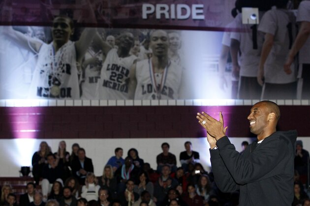 Los Angles Lakers basketball player Kobe Bryant applauds during a dedication ceremony for a new gymnasium at Lower Merion High School, Thursday, Dec. 16, 2010, in Ardmore, Pa. The gym was named and dedicated to Bryant, a Lower Merion alumnus. (AP Photo/Matt Slocum)