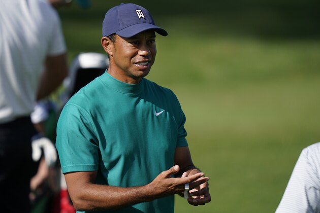Tiger Woods arrives at the practice range during a practice round for the Masters golf tournament Monday, Nov. 9, 2020, in Augusta, Ga. (AP Photo/David J. Phillip)