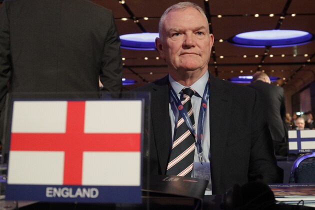 FILE - In this file photo dated Thursday, Feb. 7, 2019, England's FA Chairman Greg Clarke poses for photographers as he arrives on the occasion of the 43rd UEFA congress in Rome.  The English Football Association chairman, and FIFA vice president Greg Clarke apologized on Tuesday Nov. 10, 2020, for inappropriately referencing â€œcolored footballers