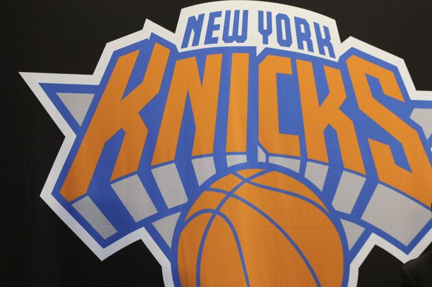 James Dolan, executive chairman of  Madison Square Garden, sits at a news conference next to the team logo where he introduced Phil Jackson as the new president of the New York Knicks, Tuesday, March 18, 2014 in New York. Jackson, who won two NBA titles as a player for the New York Knicks, also won 11 championships while coaching the Chicago Bulls and the Los Angeles Lakers. (AP Photo/Mark Lennihan)