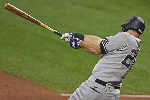 New York Yankees' DJ LeMahieu (26) hits a RBI single in the fourth inning of Game 1 of an American League wild-card baseball series against the Cleveland Indians, Tuesday, Sept. 29, 2020, in Cleveland. (AP Photo/David Dermer)