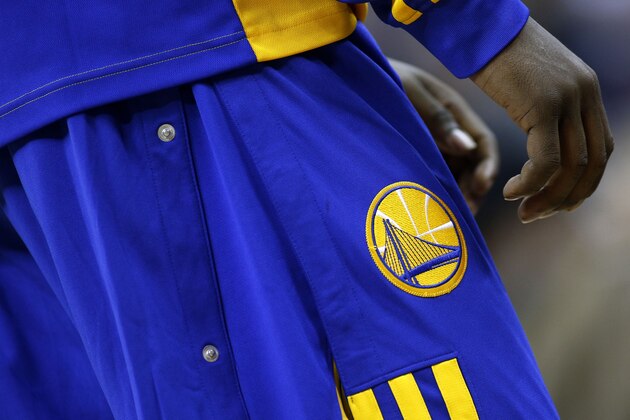 The Golden State Warriors' logo is seen during the first half of an NBA basketball game against the New Orleans Pelicans  in New Orleans, Saturday, Jan. 18, 2014. (AP Photo/Jonathan Bachman)