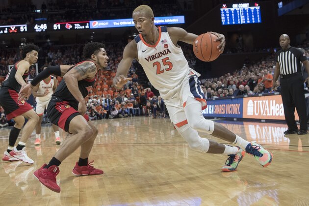 Virginia forward Mamadi Diakite (23) drives around Louisville defender Lamarr Kimble (0) during the second half of an NCAA college basketball game in Charlottesville, Va., Saturday, March 7, 2020. (AP Photo/Lee Luther Jr.)