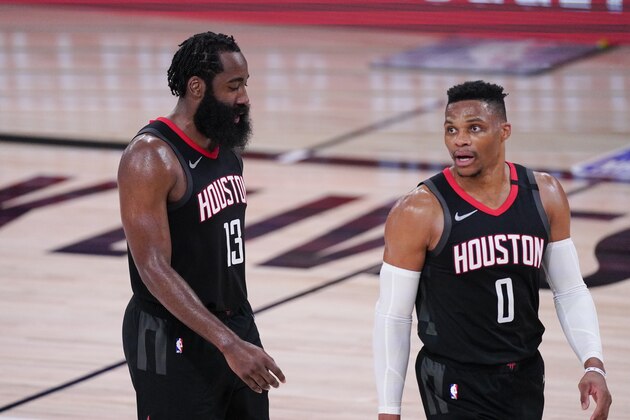 Houston Rockets' James Harden, left and Russell Westbrook walks together during the second half of an NBA conference semifinal playoff basketball game against the Los Angeles Lakers Saturday, Sept. 12, 2020, in Lake Buena Vista, Fla. (AP Photo/Mark J. Terrill)