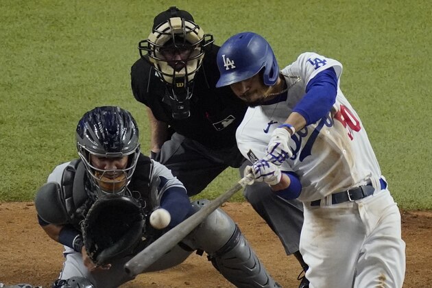 Los Angeles Dodgers' Mookie Betts hits a home run against the Tampa Bay Rays during the eighth inning in Game 6 of the baseball World Series Tuesday, Oct. 27, 2020, in Arlington, Texas. (AP Photo/Sue Ogrocki)
